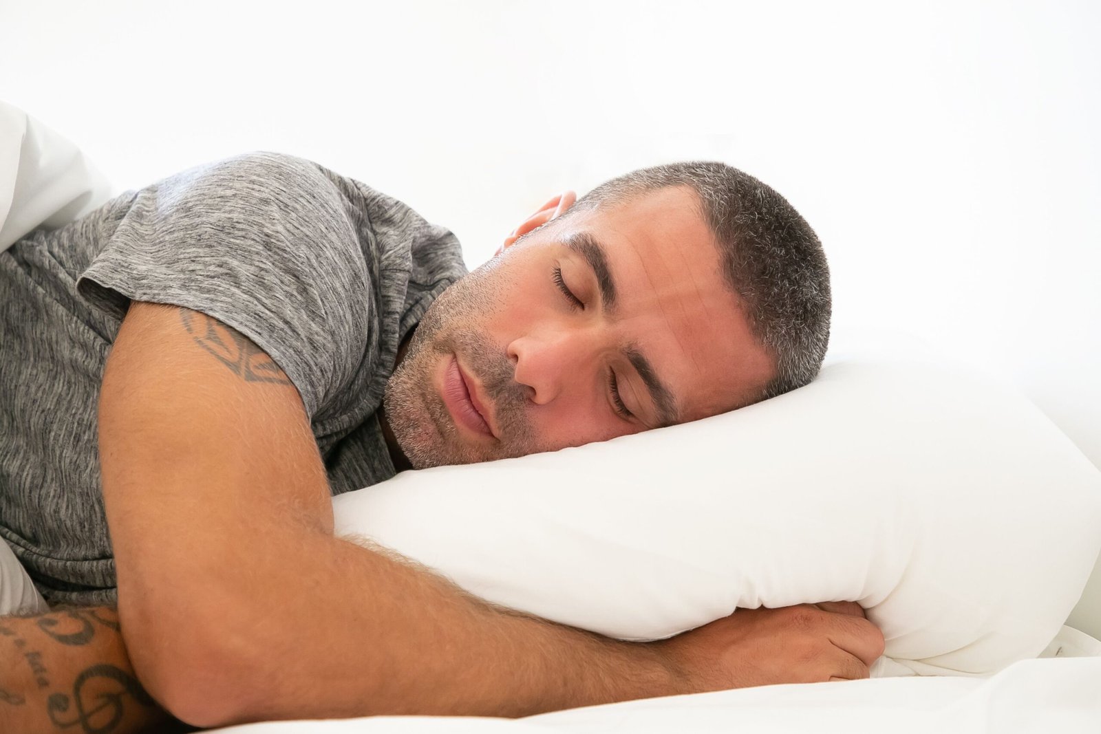 Serene image of a man resting peacefully on a pillow, capturing a moment of calm and relaxation.